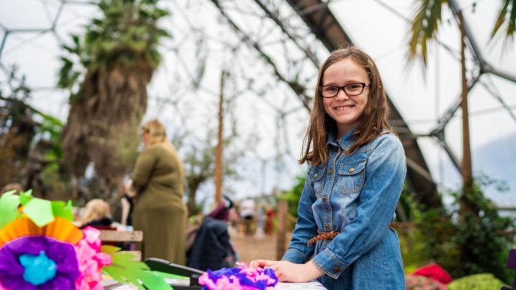 Girl doing craft activity in Eden's Mediterranean Biome