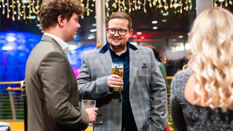 Men enjoying drinks at a Christmas party at the Eden Project