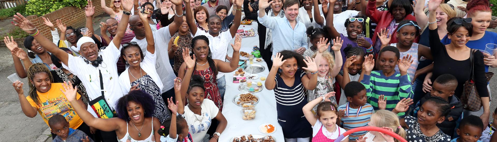 People waving at a street party 