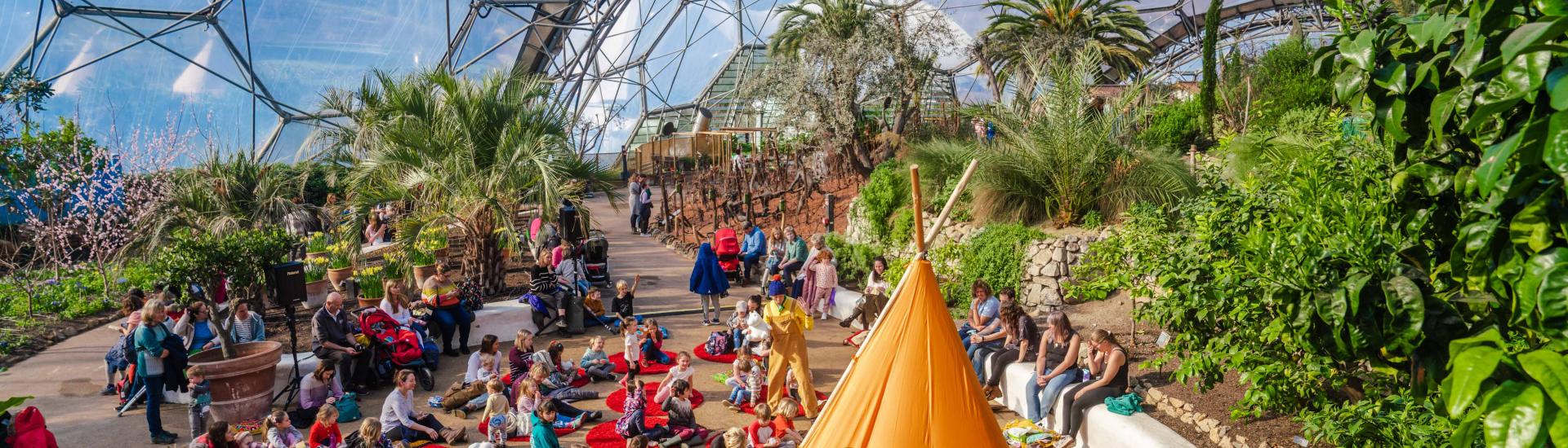 Wide shot of visitors watching Moomin storytelling in the Med Biome