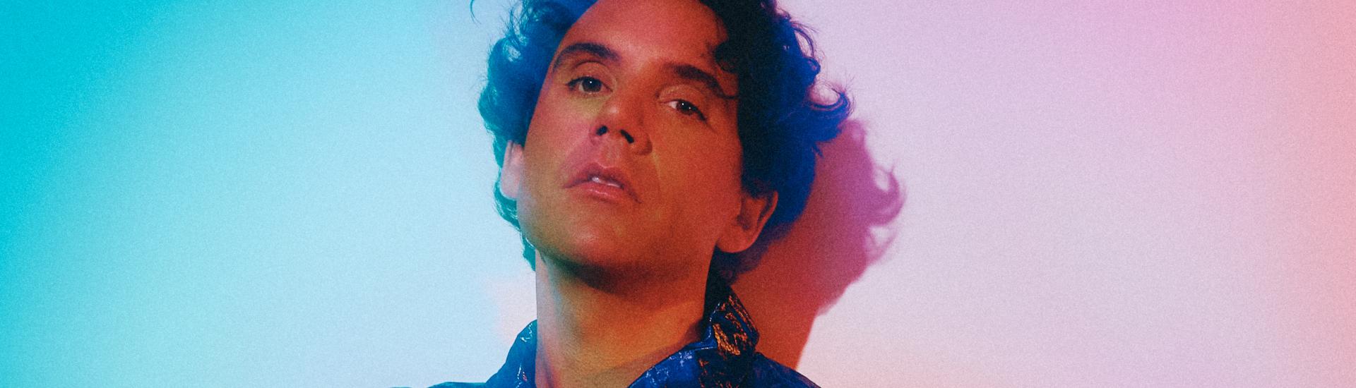 Popstar Mika bathed in coloured light